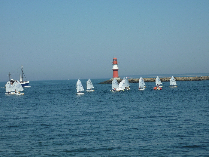 Roter Leuchturm Warnemünde / the red lighthouse of Warnemünde with some sailing boats and young sailsmen